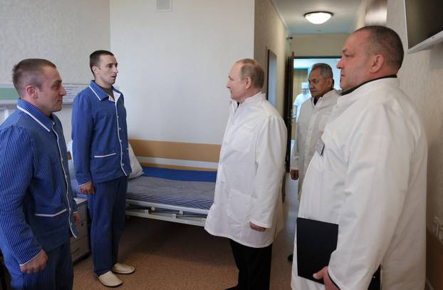 Russian President Vladimir Putin visits soldiers wounded during the conflict in Ukraine at a hospital in Moscow
