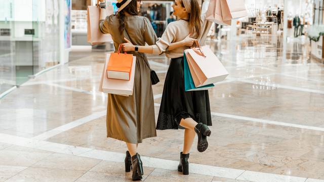 Shopping,And,Entertainment,,Mall,Inside.,Two,Beautiful,Girls,With,Paper
