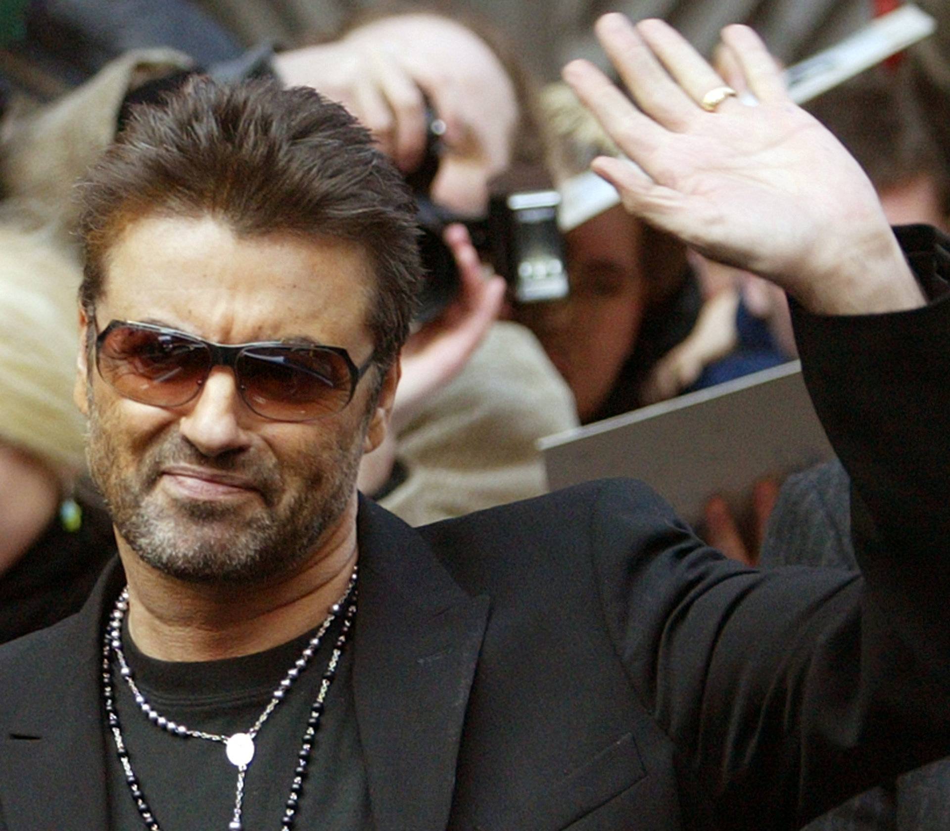 FILE PHOTO: British singer and actor George Michael waves as he leaves a news conference to introduce the film 'George Michael: A Different Story'  in Berlin