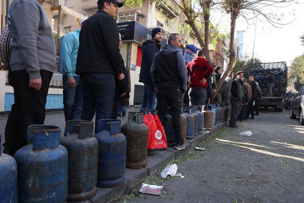 People queue to fill their gas cylinders in Damascus