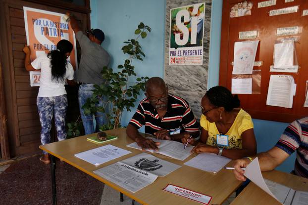 Officials prepare a polling station for the constitutional referendum in Havana