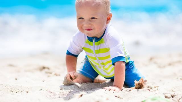 Baby boy on tropical beach