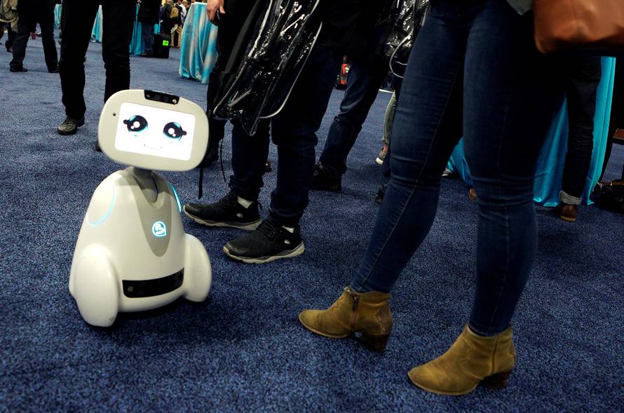 A Buddy robot by Blue Frog roams the floor during the opening event at CES in Las Vegas