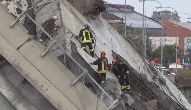 Rescue workers are seen at the collapsed Morandi Bridge in the Italian port city of Genoa