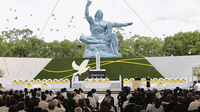 Doves fly over the Peace Statue during a ceremony commemorating the 77th anniversary of the bombing of the city at Nagasaki Peace Park in Nagasak
