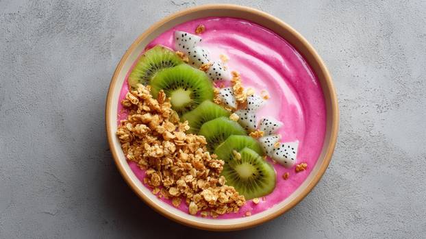 Vibrant and Healthy Smoothie Bowl Topped with Kiwi, Dragon Fruit, and Crunchy Granola for a Refreshing Breakfast Delight
