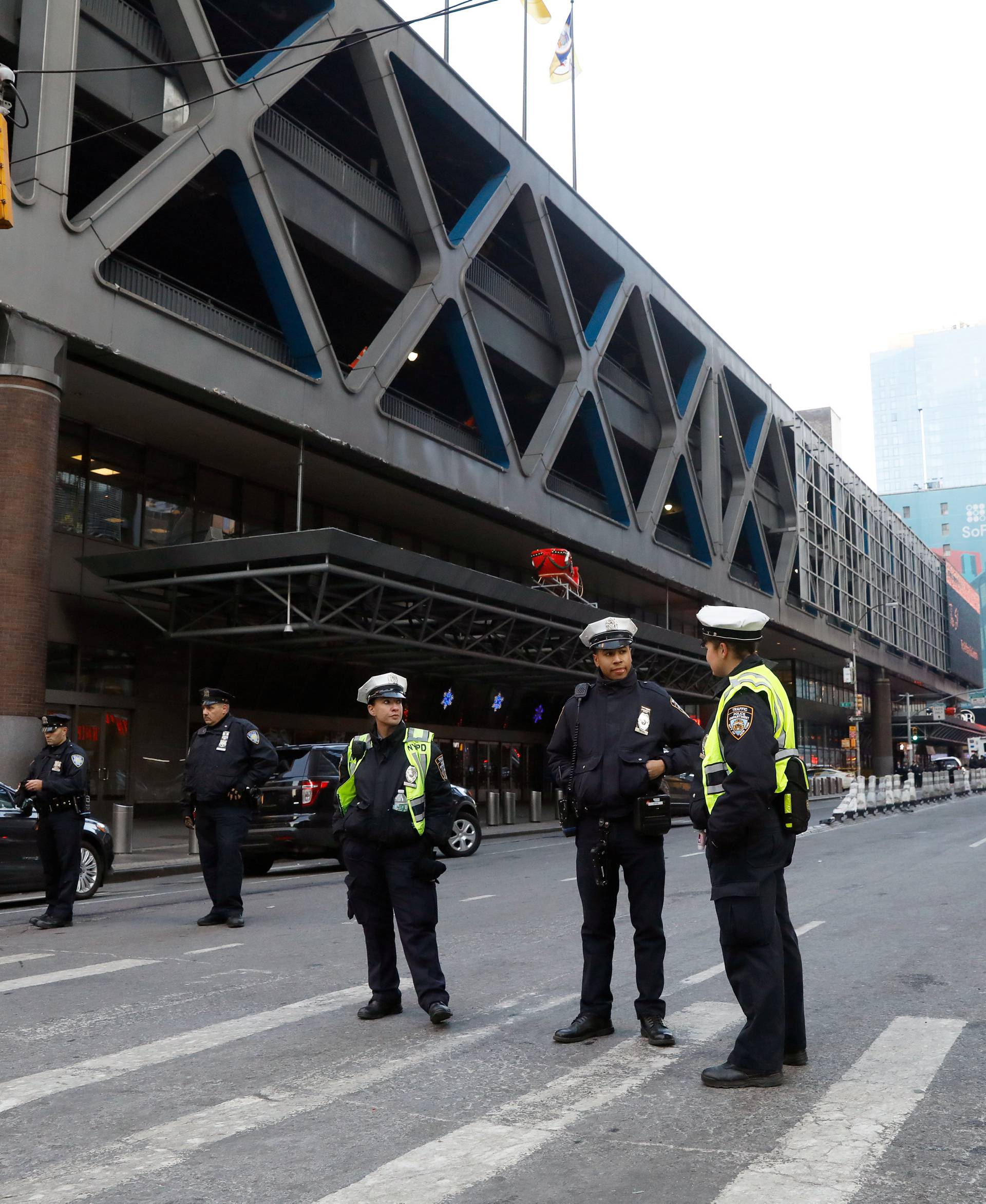 Police officers stand outside the New York Port Authority Bus Terminal in New York City after reports of an explosion