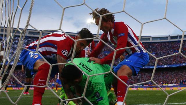 Atletico Madrid's Antoine Griezmann and Jose Gimenez retrieve the ball from Real Madrid's Keylor Navas after Saul Niguez (not pictured) scores their first goal