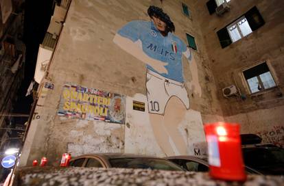 A mural of Argentine soccer legend Diego Maradona is seen in the Spanish Quarter of Naples after the announcement of his death, in Naples