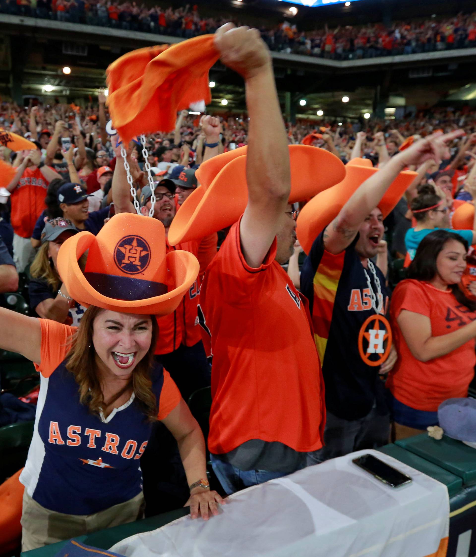 Astros fans watch and cheer as their team plays in Los Angeles during a World Series Game Seven watch party in Houston