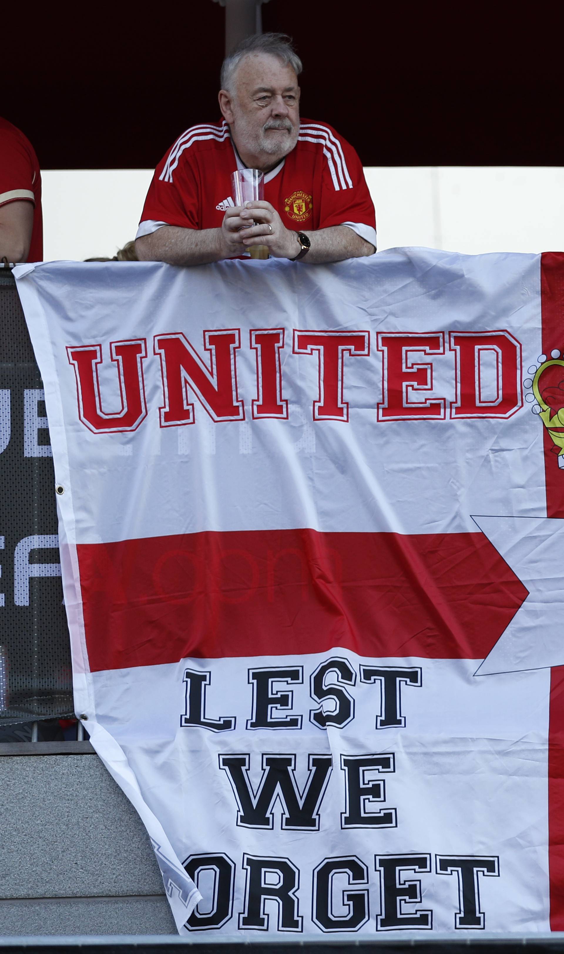 Manchester United fans display a banner in reference to the terror attack in Manchester before the match