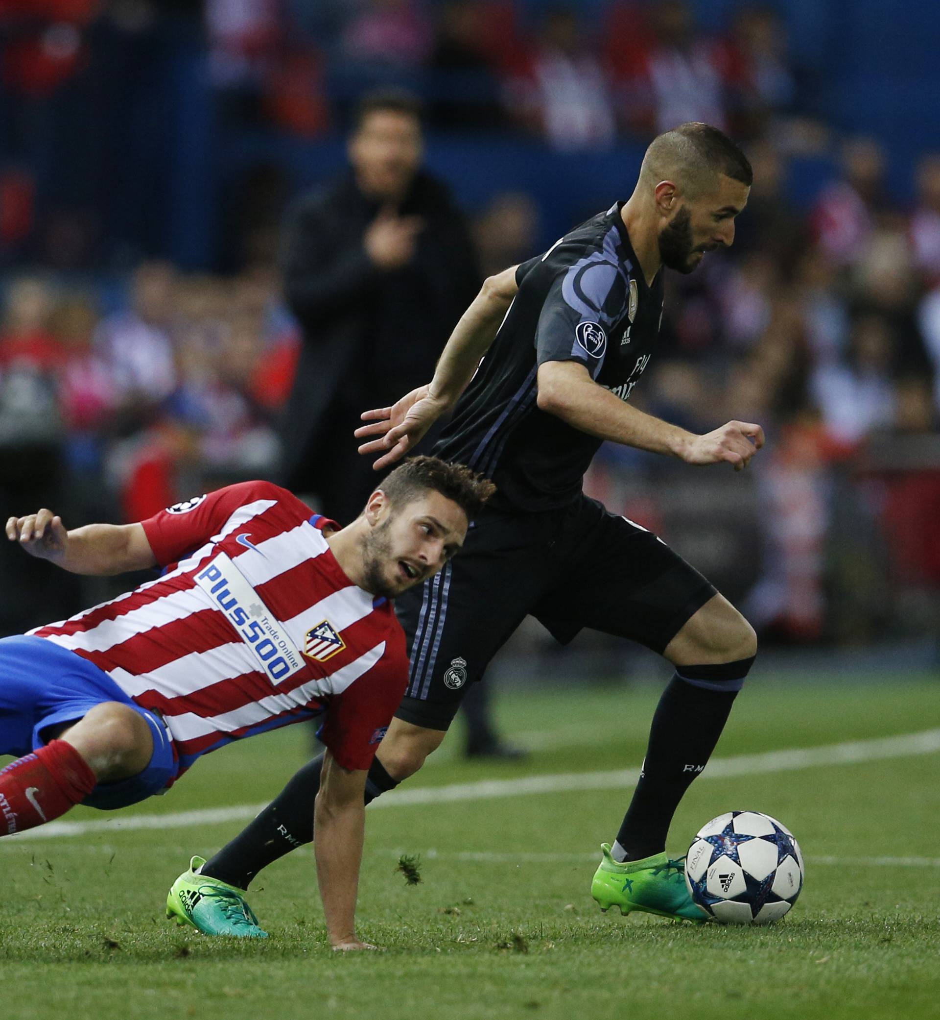Real Madrid's Karim Benzema in action with Atletico Madrid's Koke