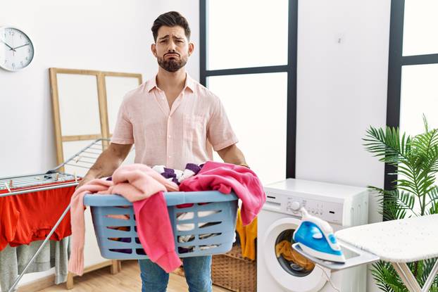 Young,Man,With,Beard,Holding,Laundry,Basket,Depressed,And,Worry