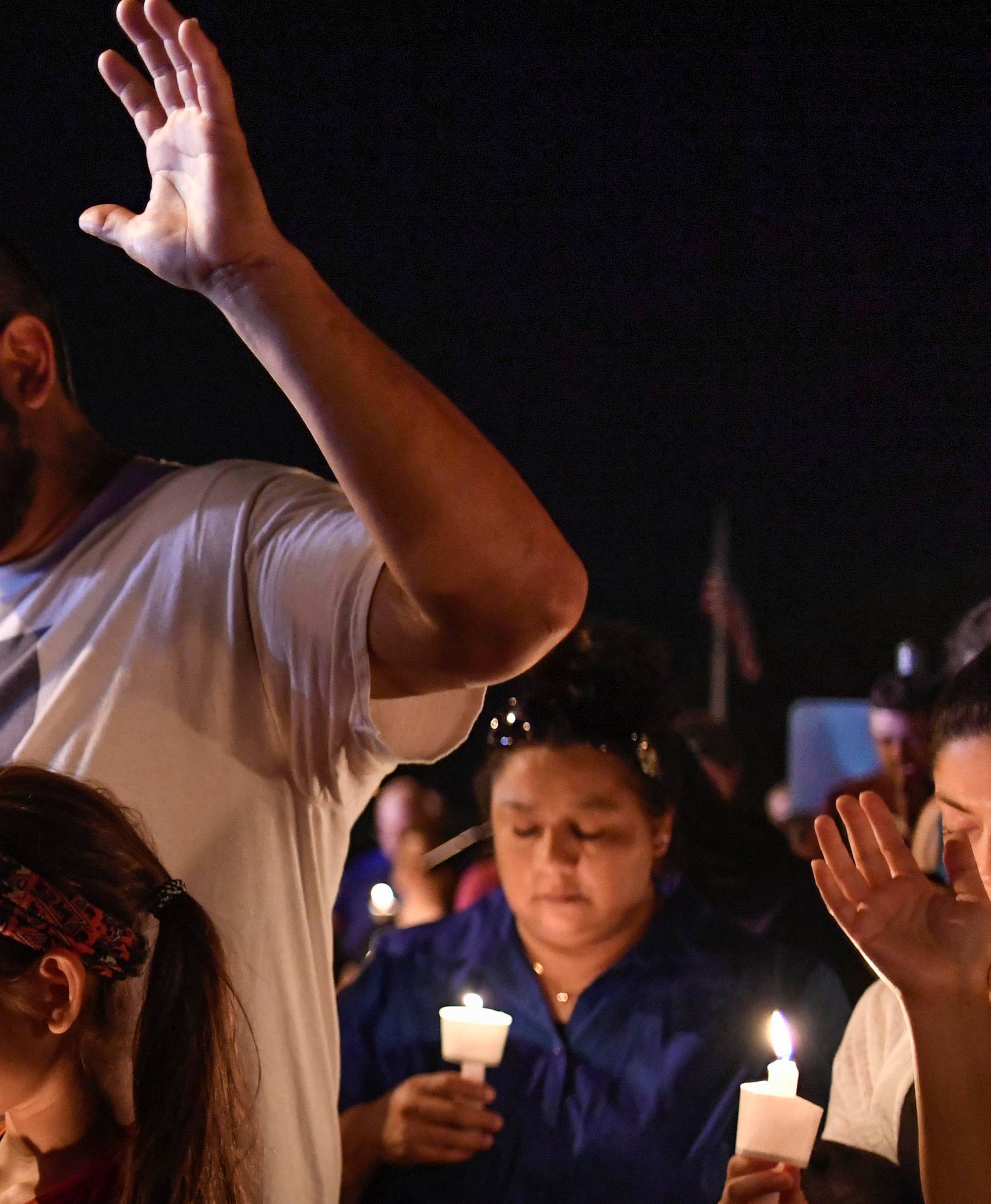 Local residents embrace during a candlelight vigil for victims of a mass shooting in a church in Sutherland Springs, Texas