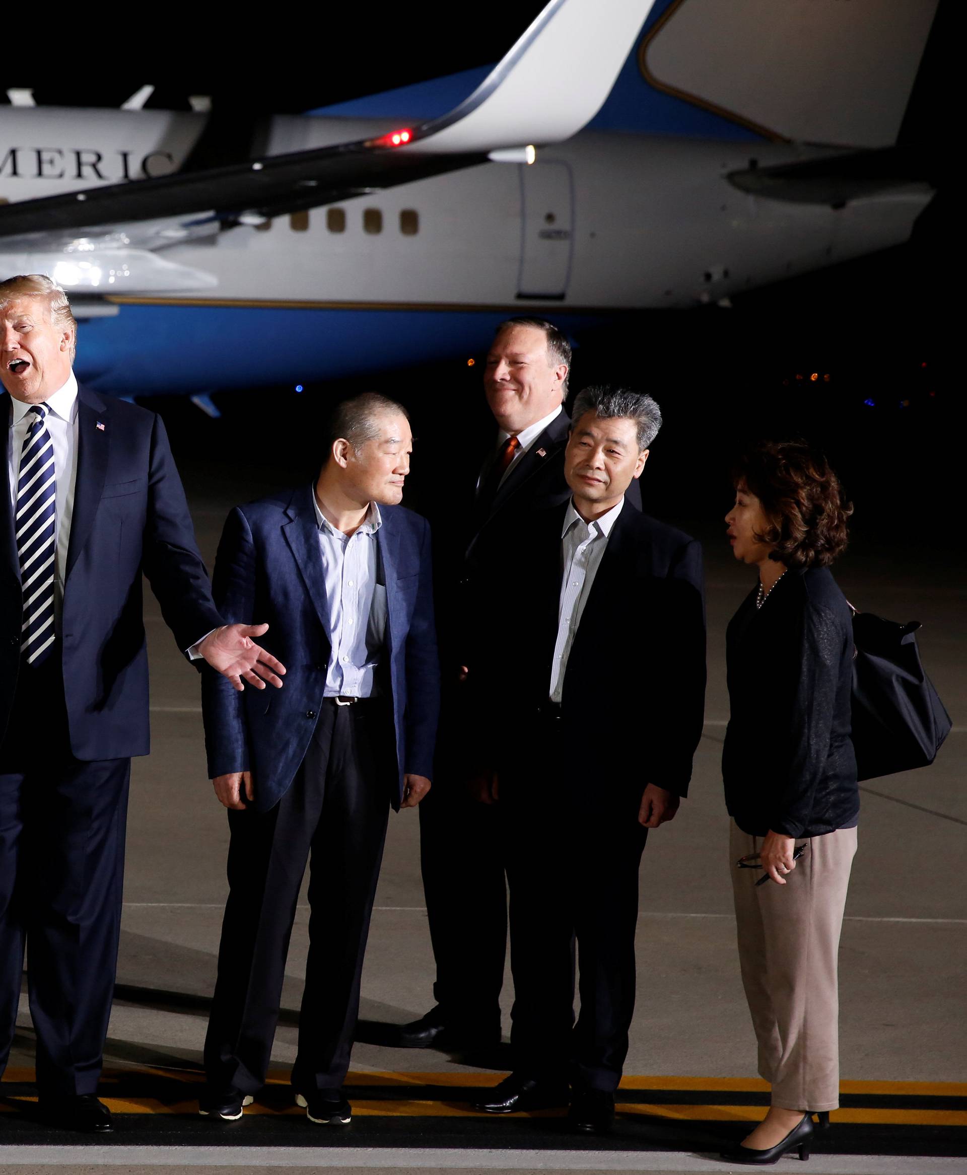 President Donald Trump talks to the media next to the three Americans formerly held hostage in North Korea, Tony Kim, Kim Hak-song and Kim Dong-chul, upon their arrival at Joint Base Andrews