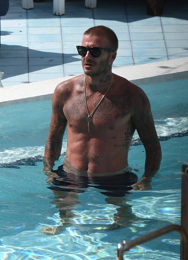 Shirtless David Beckham celebrates his new team, Inter Miami, as he has a few cocktails and takes a dip in the pool in Miami