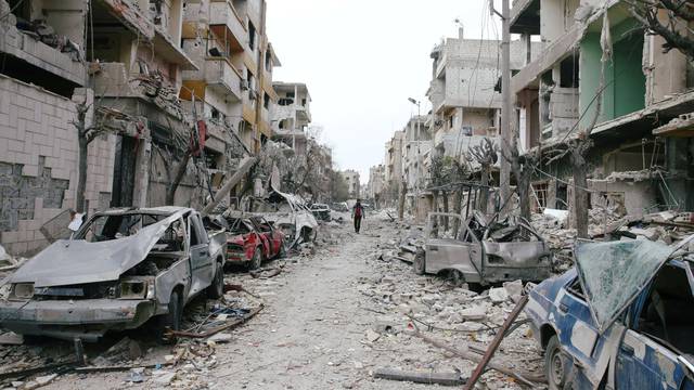 Damaged cars and buildings are seen in the besieged town of Douma, Eastern Ghouta, Damascus