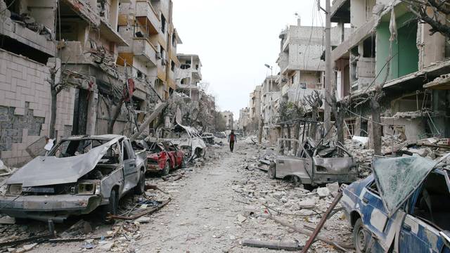 Damaged cars and buildings are seen in the besieged town of Douma, Eastern Ghouta, Damascus