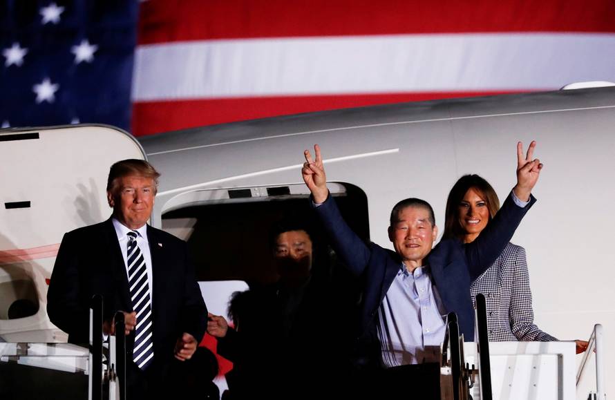 One of the Americans formerly held hostage in North Korea gestures next to U.S.President Donald Trump and first lady Melania Trump, upon their arrival at Joint Base Andrews