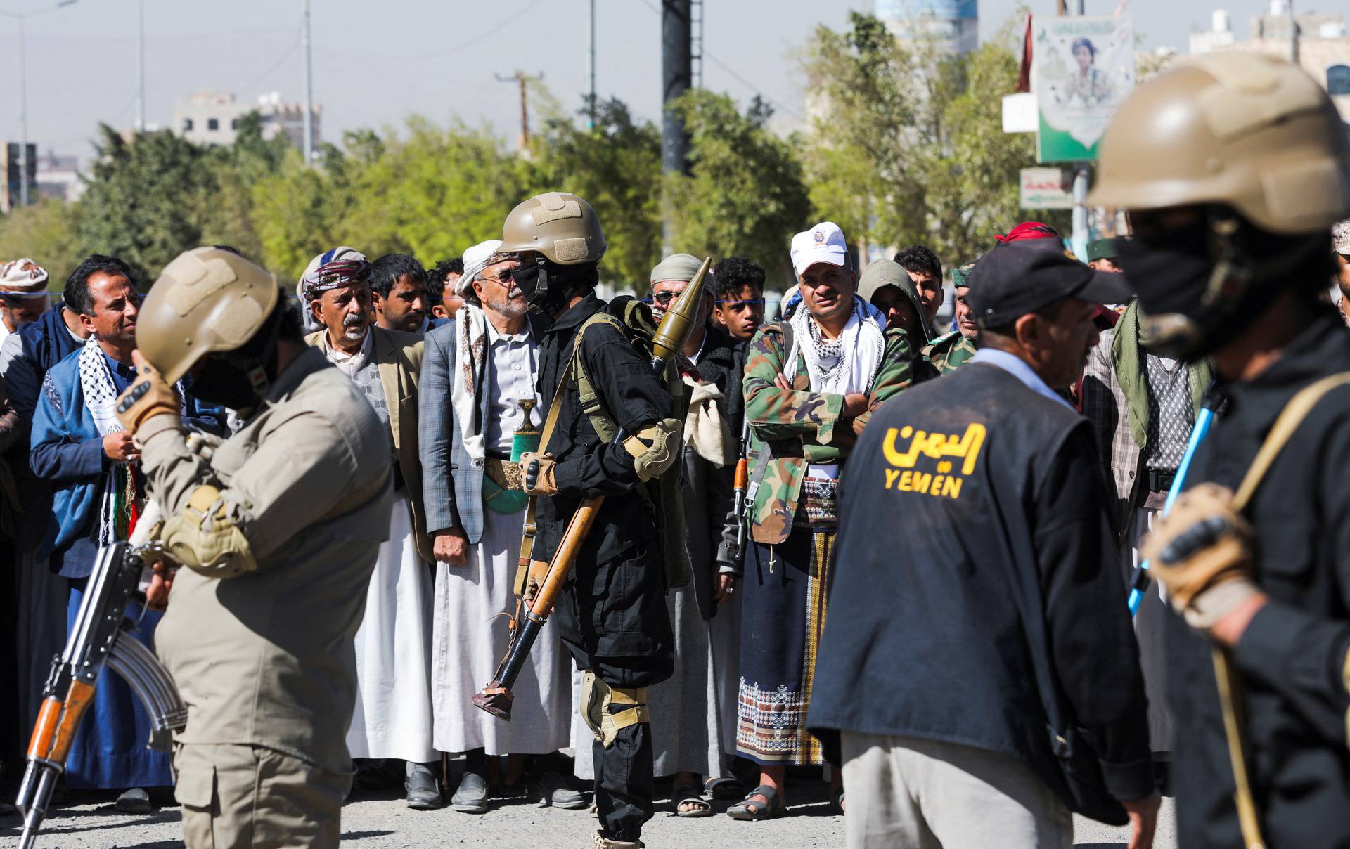 Houthi fighters stand guard during a ceremony at the end of the training of newly recruited Houthi fighters in Sanaa