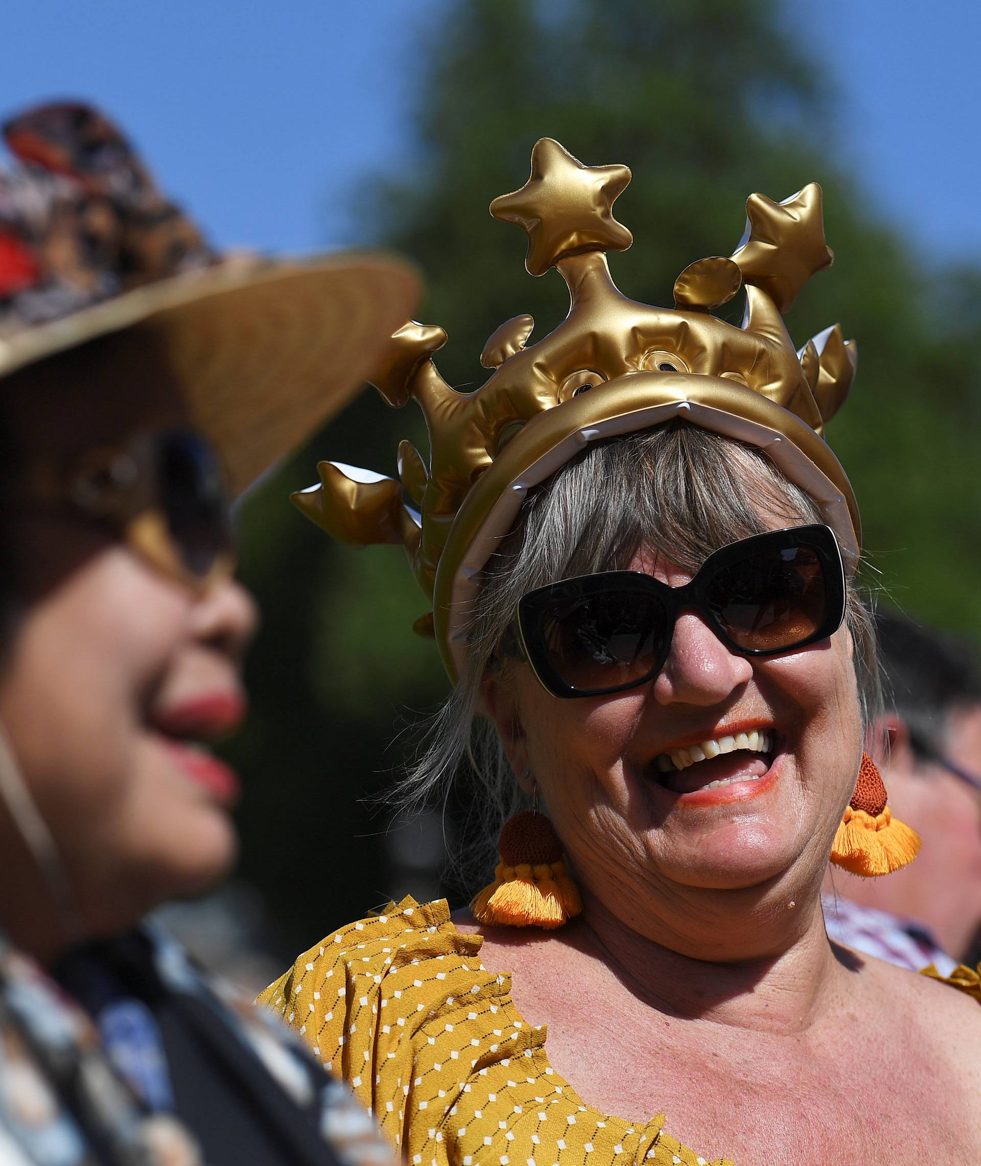 Women wear novelty headgear outside Windsor Castle ahead of Britain's Prince Harry's wedding to Meghan Markle in Windsor