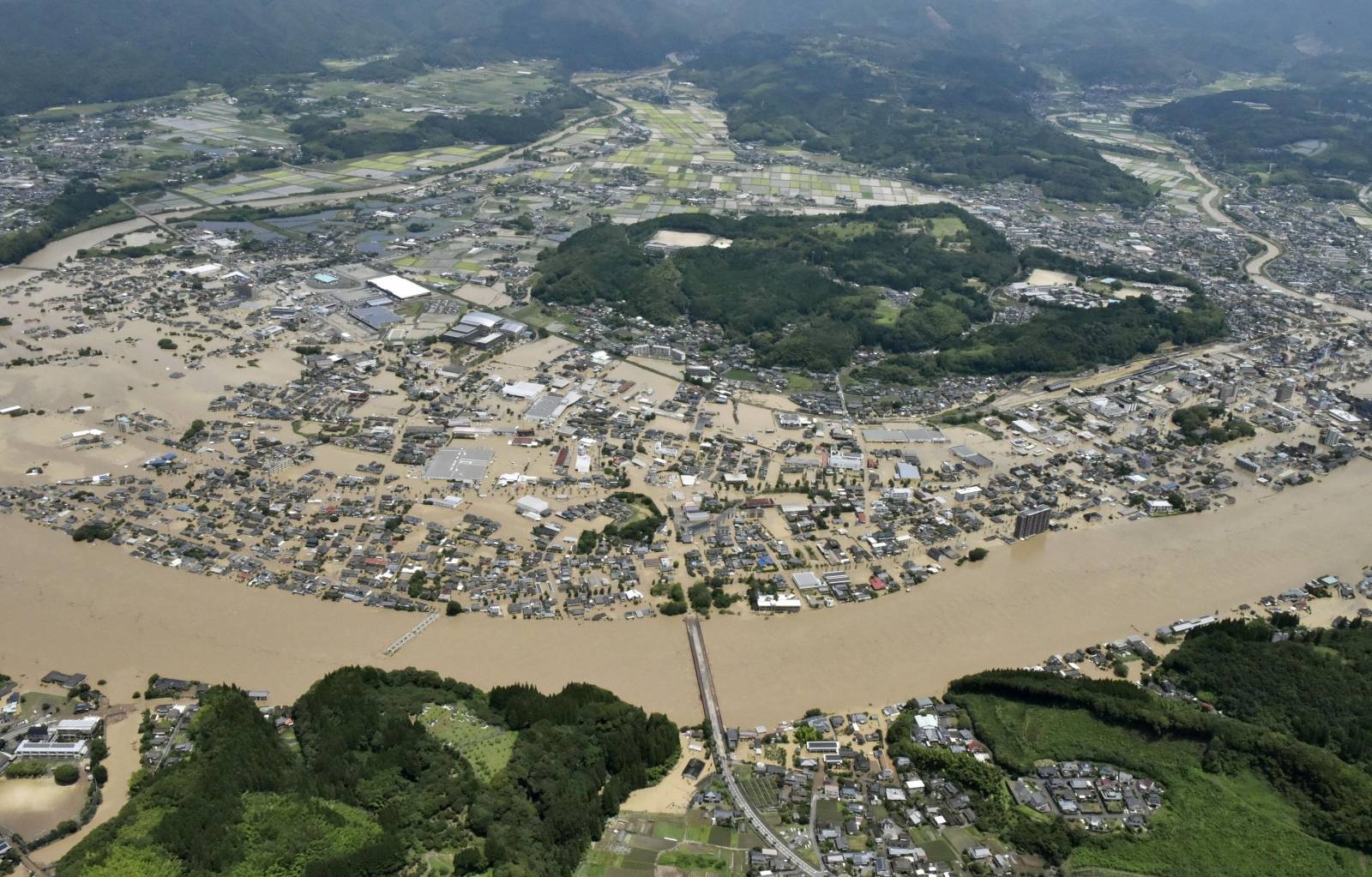 An aerial view shows flooded Kuma River caused by a heavy rain at a residential area in Hitoyoshi, Japan