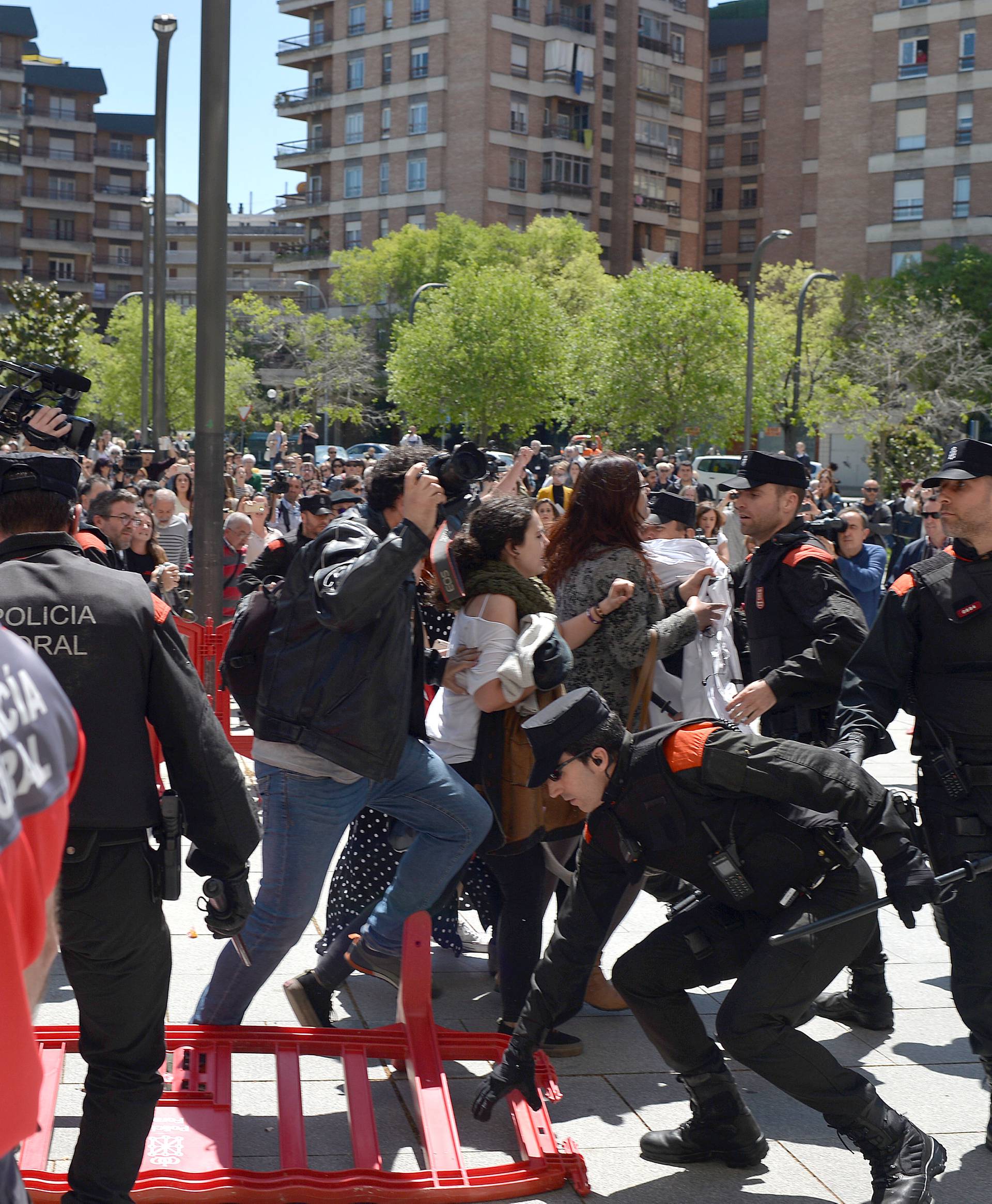 Protesters break through a police line after a nine-year sentence was given to five men accused of the multiple rape of a woman during Pamplona's San Fermin festival in 2016