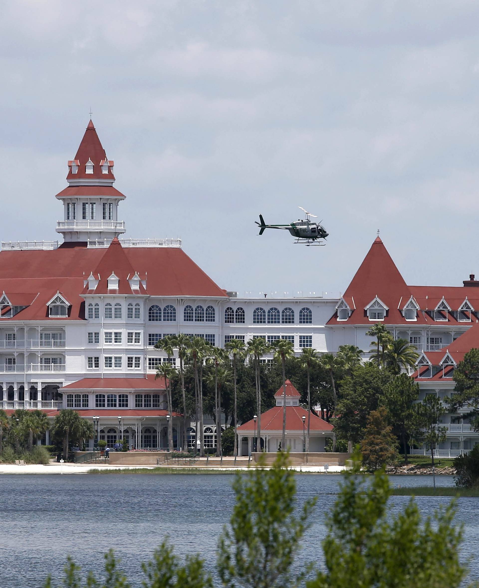 A Florida Fish and Wildlife Conservation Commission helicopter flies over lagoon at Walt Disney World resort in Orlando, Florida