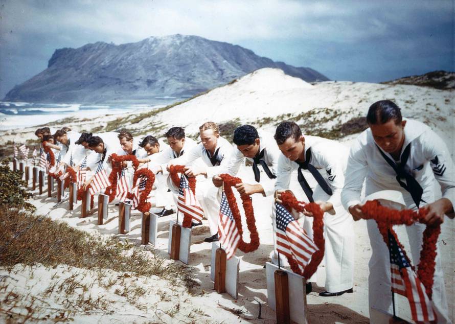 Archive photo of Sailors honoring men killed during the Japanese Pearl Harbor attack the previous year on Naval Air Station Kaneohe