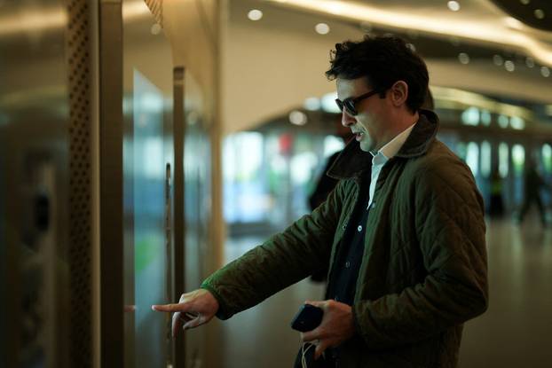 A passenger buys his metro pass at the King Abdullah Financial District Metro Station in Riyadh