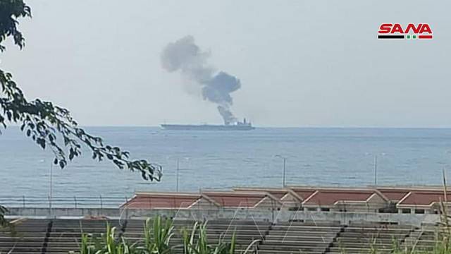Smoke rises from a tanker off the coastal city of Baniyas