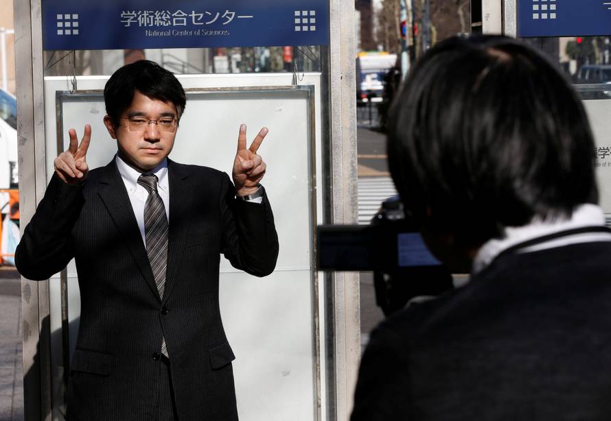 Echizen, a professor at Japan's National Institute of Informatics, gestures during a demonstration of his experiment for Reuters in Tokyo