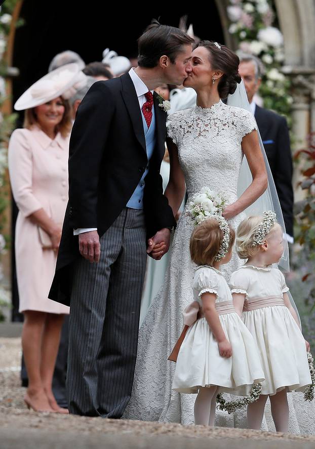 Pippa Middleton and James Matthews kiss after their wedding at St Mark