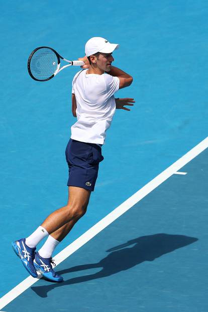 Novak Djokovic practices on court ahead of 2022 Australian Open