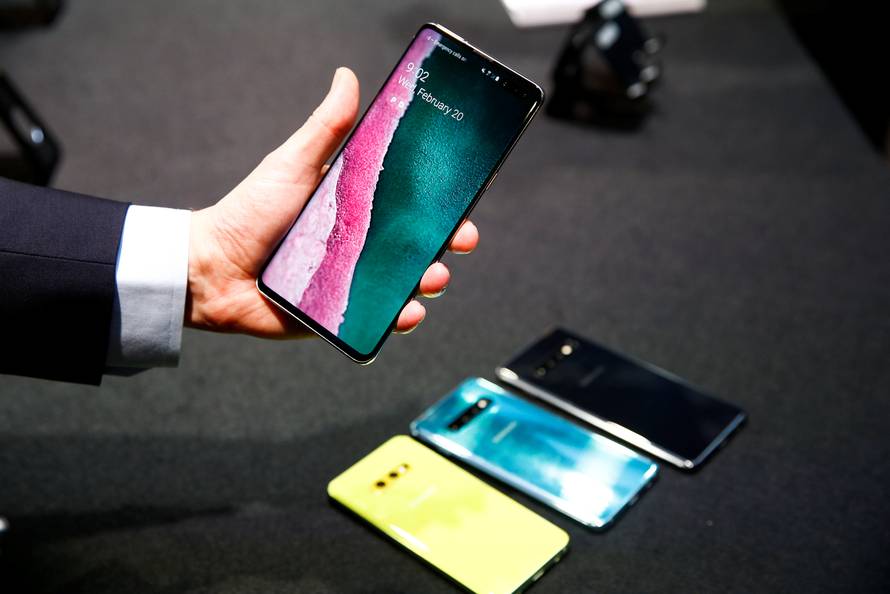 A journalist holds the new Samsung Galaxy S10 smartphone at a press event in London