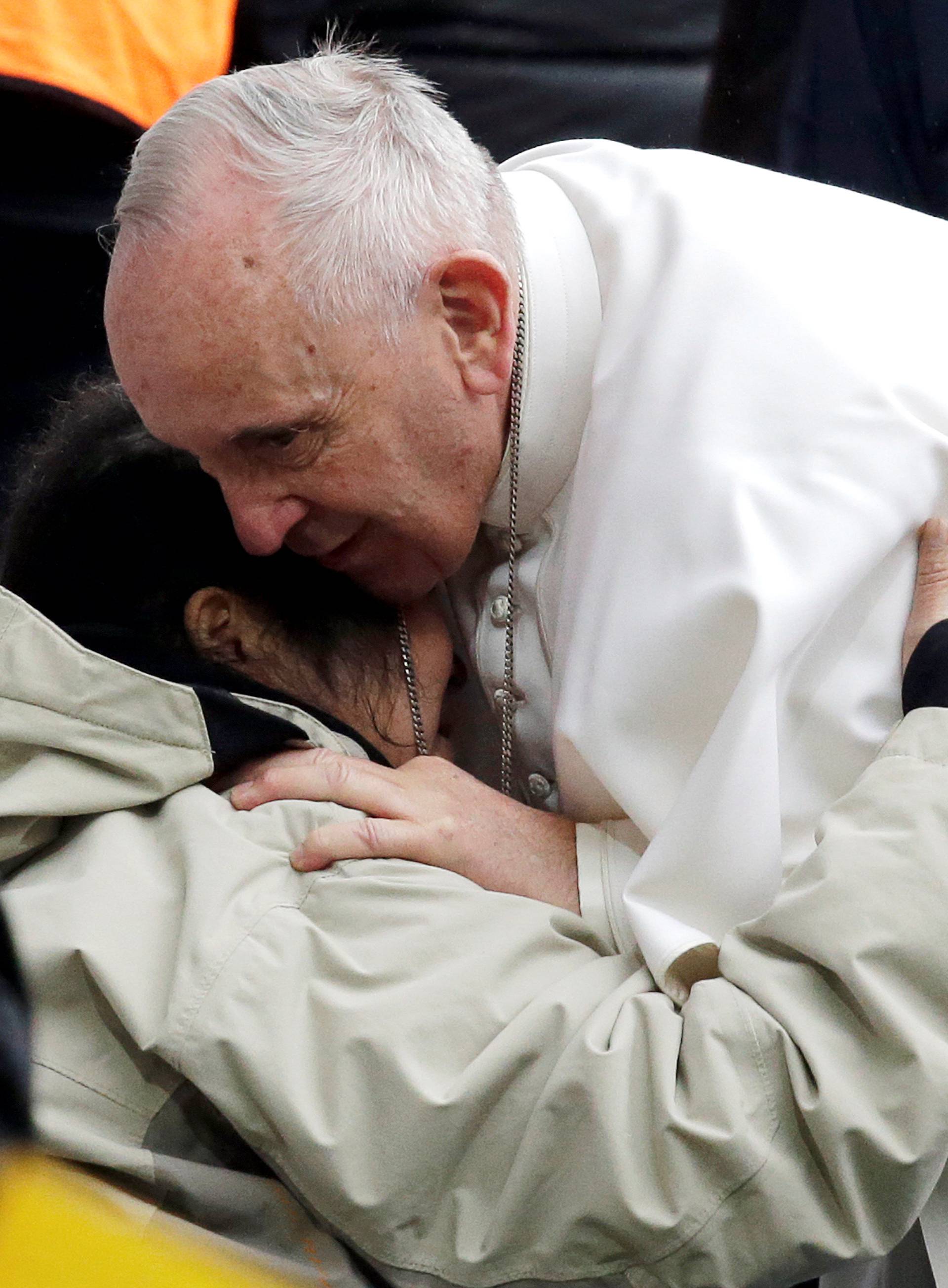 Pope Francis embrace a sick woman as he arrives to lead a Holy Mass at the Swedbank Stadion in Malmo