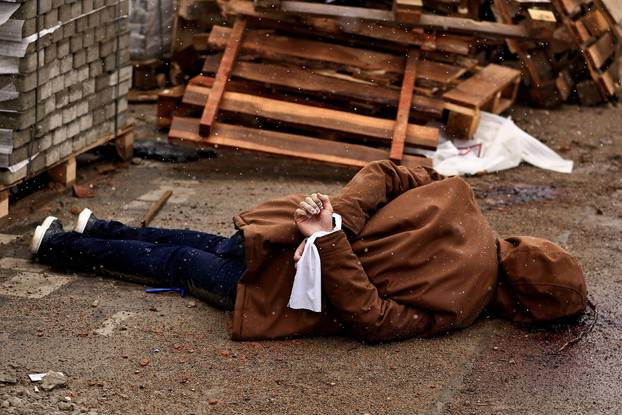 The Wider Image: In Ukrainian street, a corpse with hands bound and a bullet wound to the head