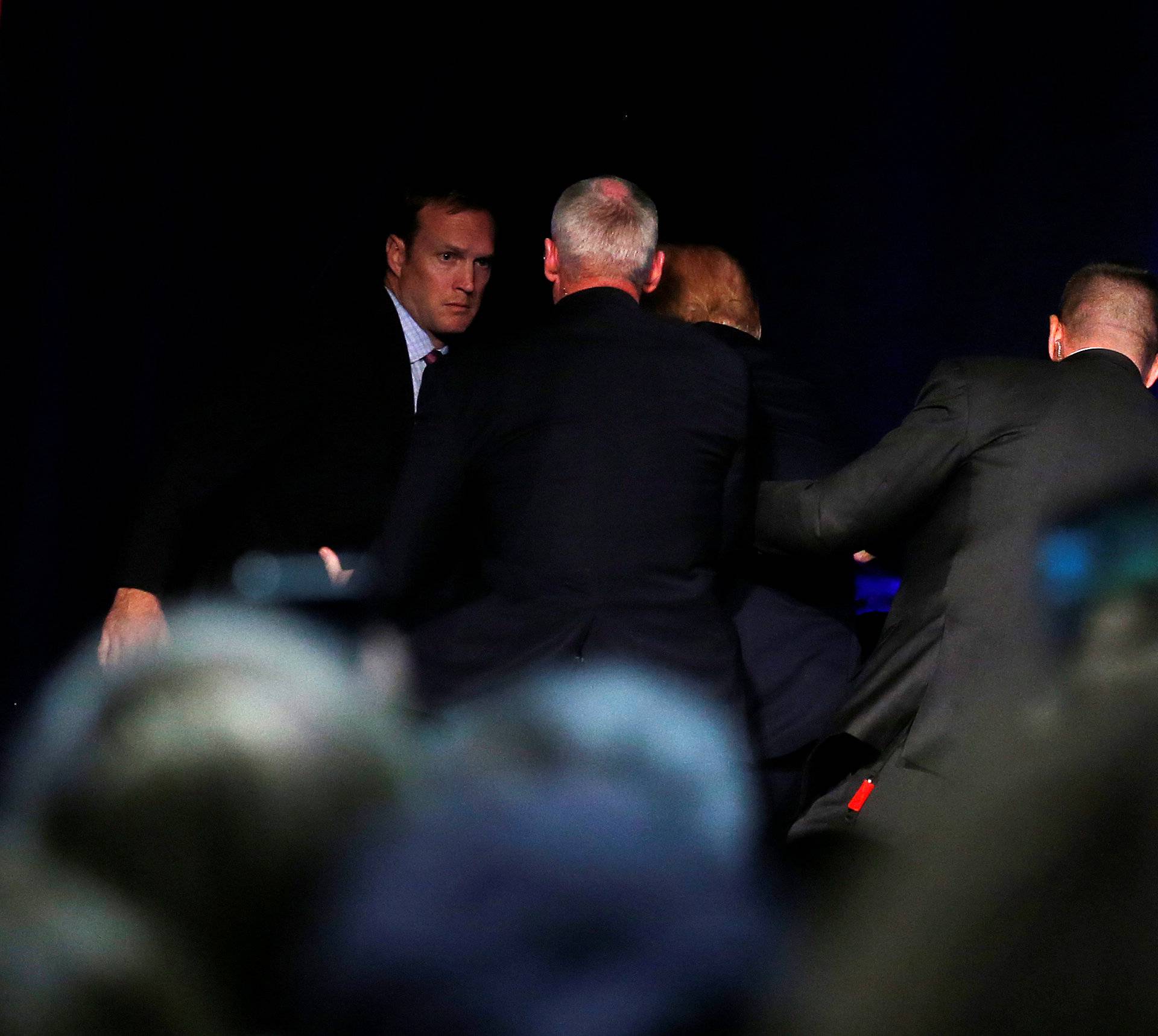 Republican presidential nominee Donald Trump is hustled off the stage by security agents following a perceived threat in the crowd at a campaign rally in Reno, Nevada