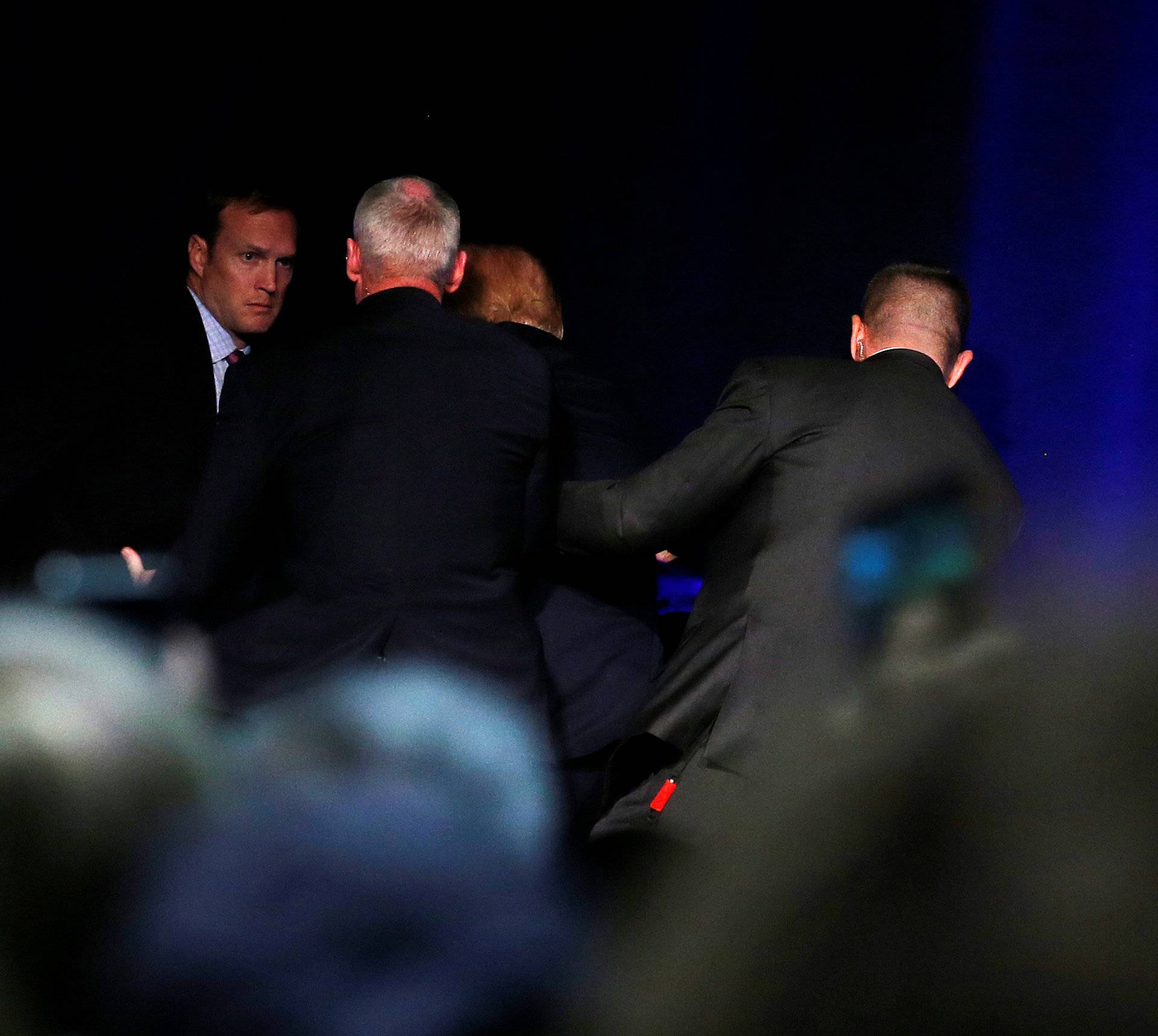 Republican presidential nominee Donald Trump is hustled off the stage by security agents following a perceived threat in the crowd at a campaign rally in Reno, Nevada