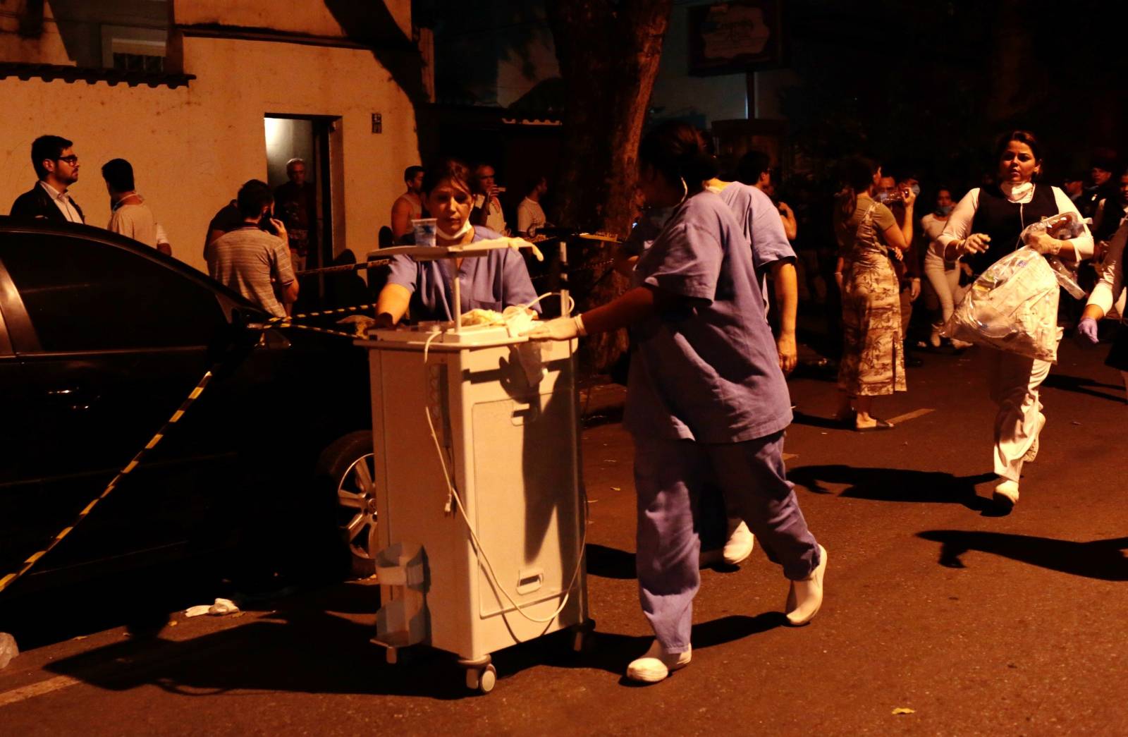 Employees move medical equipment after a fire hit the Badim Hospital in Rio de Janeiro,
