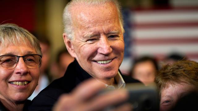 Democratic presidential candidate and former Vice President Joe Biden takes a selfie with supporters at a campaign event in Somersworth