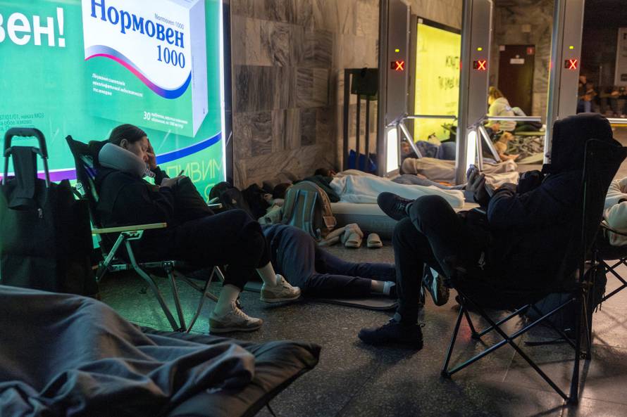 People take shelter in a metro station during a Russian drone attack in Kyiv