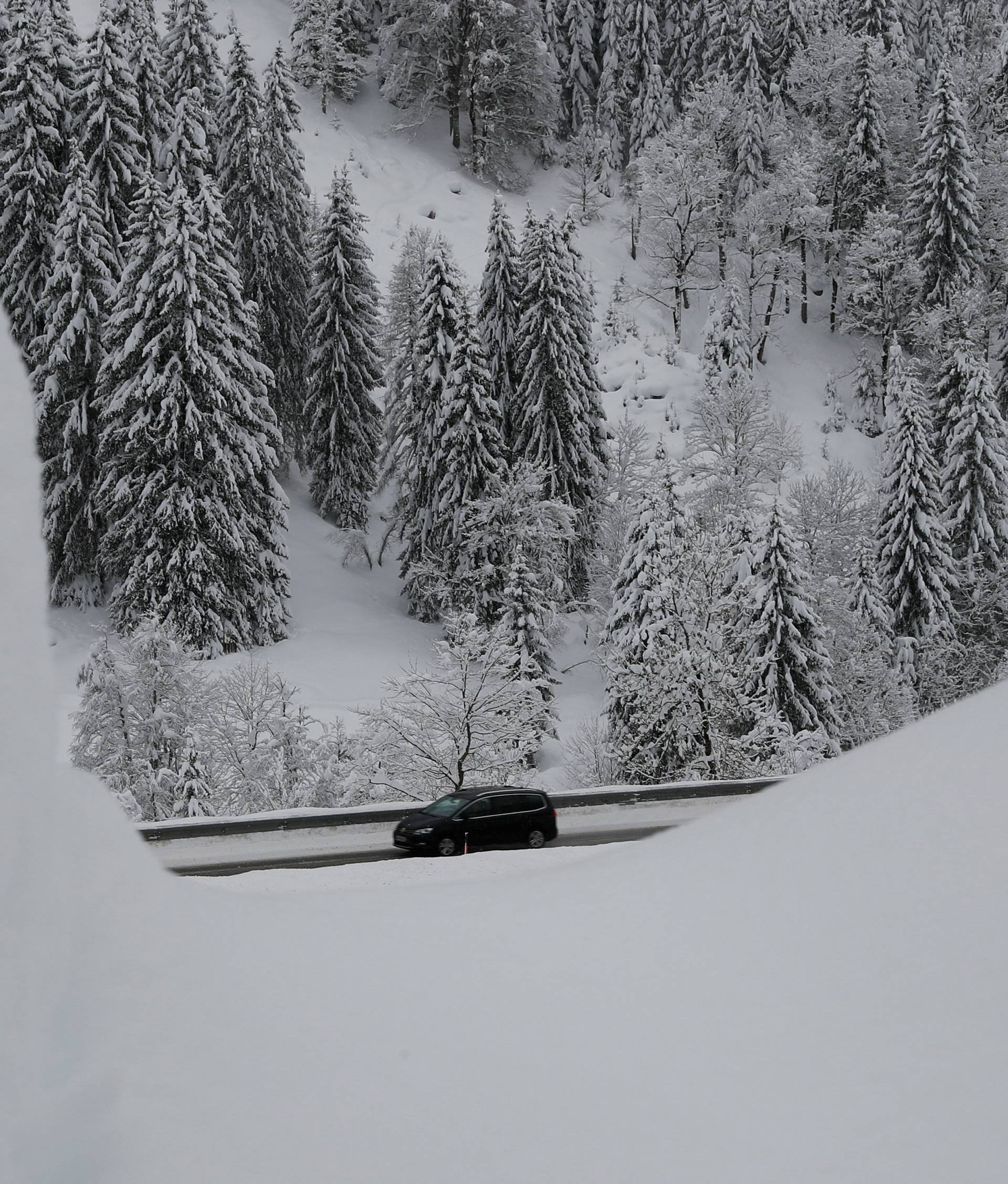 A car drives on the road after heavy snowfall in Untertauern