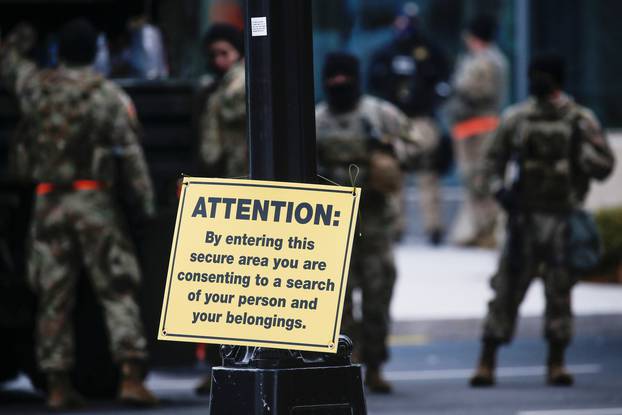 A placard with information for pedestrians is seen on a post as members of the National Guard secure the area near the Capitol for possible protest ahead of U.S. President-elect Joe Biden