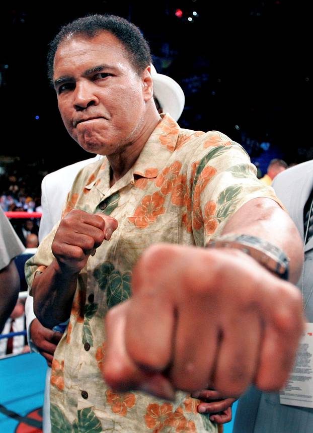 File photo of boxing great Muhammad Ali showing his fists as he stands in the ring after daughters fight in Washington