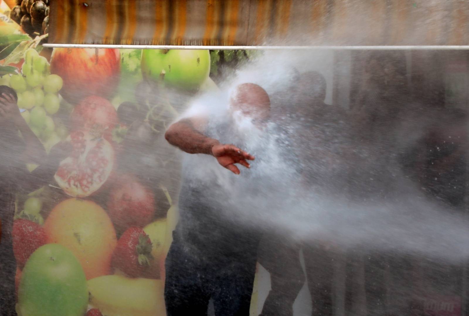 Turkish police use a water cannon to disperse demonstrators during a protest against the replacement of Kurdish mayors with state officials in three cities, in Diyarbakir