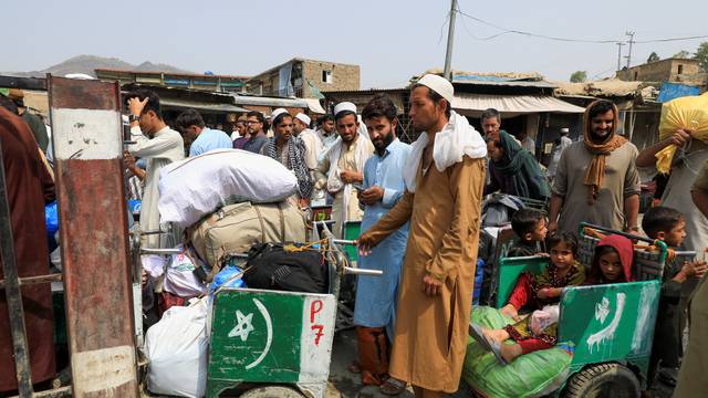 People wait to cross main Pakistan-Afghan border crossing in Torkham