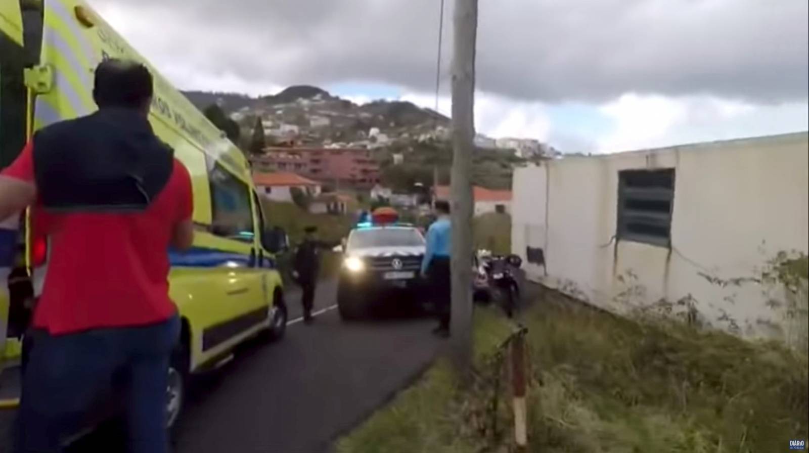 Emergency responders are seen at the site of a bus accident in Canico