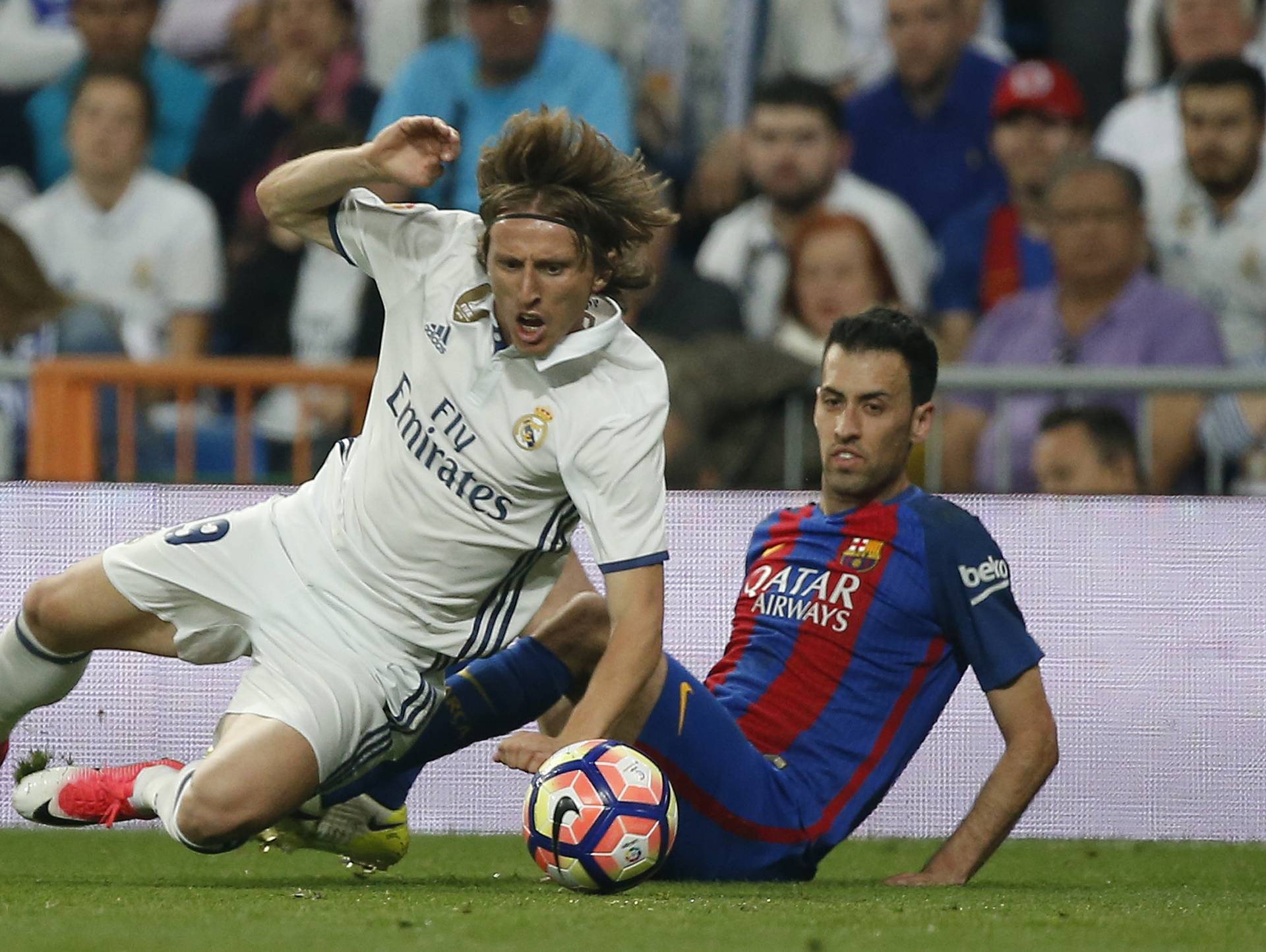Real Madrid's Luka Modric in action with Barcelona's Sergio Busquets