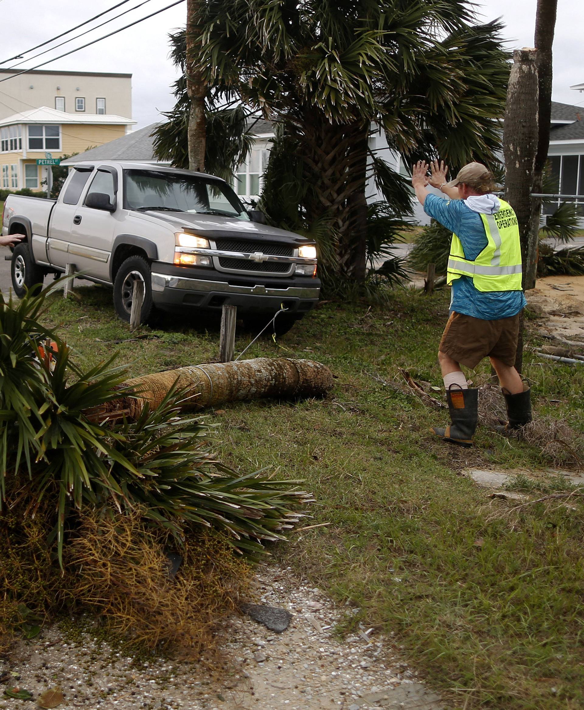 Emergency crews work to clear a street of debris during Hurricane Michael in Panama City Beach